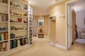 Apartment hallway with shelves and chair