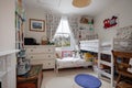 Traditional childs bedroom with high bed and cot bed