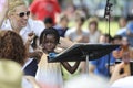 A black girl learns how to become a conductor.