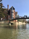 Cambridge, UK - April 20, 2019: View of Jerwood library and the orgasm bridge crossing the river Cam on a sunny day Royalty Free Stock Photo