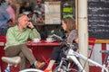 Cambridge, UK, August 1, 2019. Bicycles parked outside a restaurant along the narrow street