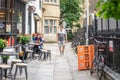 Cambridge, UK, August 1, 2019. Cafe on a narrow street with bicycles parked next to it