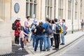 Cambridge, UK, August 1, 2019. Guide tells tourists about Cambridge University Cavendish Laboratory