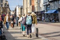 Cambridge, UK, August 1, 2019. Turists walking down using a Pair of Antishock Hiking Sticks or Walking Poles at the street of Royalty Free Stock Photo