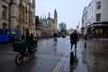 Cambridge UK December 2020 Rainy cold wet december day on the streets of Cambridge city, people walking by and cyclists driving on