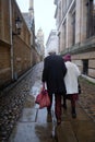 Cambridge UK December 2020 Rear view of an older couple walking through the Senate House Passage street in the center of Cambridge
