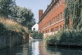 Landscape of river Cam, old colleges view and punting boats, Cambridge university campus buildings