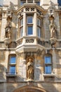 Close-up on the main entrance at Gonville and Caius College University with statues and carvings