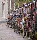 Cambridge, UK - October 9, 2019: Bicycles parked against the fence with a lot of posters