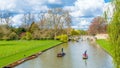 Cambridge, United Kingdom - 17 June, 2016 : People punting on river cam on a bright sunny summer weekend, Cambridge Royalty Free Stock Photo