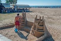 Cambrils Spain June 18 August 13 year. A man builds a sand castle. The main attraction of Cambrils is 9 km of sandy beach