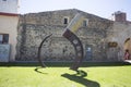 Cambrils, Spain, May 1, 2020 - sickle sculpture on ancient city wall backdrop Royalty Free Stock Photo