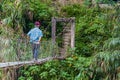 CAMBULO, PHILIPPINES - JANUARY 21, 2018: Local man is crossing a hanging bridge near Cambulo village, Luzon island