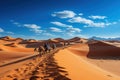 Camel caravan in the desert at sunset. Travel Concept. Background with a copy space. Royalty Free Stock Photo