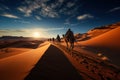 Camel caravan in the desert at sunset. Travel Concept. Background with a copy space. Royalty Free Stock Photo