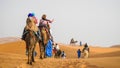 Camel caravan going through the sand dunes in the Sahara Desert, Morocco Royalty Free Stock Photo