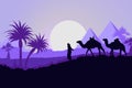 Camel caravan with pyramids and desert landscape, sunset or sunrise. Royalty Free Stock Photo