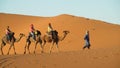 Camel driver with tourist camel caravan Royalty Free Stock Photo