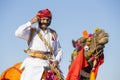 Camel and indian men wearing traditional Rajasthani dress participate in Mr. Desert contest as part of Desert Festival in Jaisalme