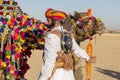 Camel and indian men wearing traditional Rajasthani dress participate in Mr. Desert contest as part of Desert Festival in Jaisalme