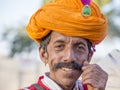 Camel and indian men wearing traditional Rajasthani dress participate in Mr. Desert contest as part of Desert Festival in Jaisalme