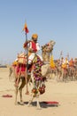 Camel and indian men wearing traditional Rajasthani dress participate in Mr. Desert contest as part of Desert Festival in Jaisalme