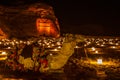 Camel laying in front of ancient tombs of Hegra city illuminated during the night, Al Ula Royalty Free Stock Photo
