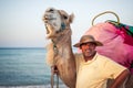 Camel owner on the coast of Tunisia with his camel, close-up Royalty Free Stock Photo
