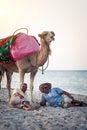 Camel owner on the coast of Tunisia with his camel, close-up Royalty Free Stock Photo