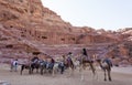 Camel riders in front of Roman amphitheatre. Petra. Jordan. Royalty Free Stock Photo