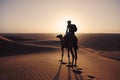 Camel riding in desert at golden sunset Royalty Free Stock Photo