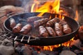 camel sausages sizzling over hot coals