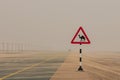 Camel warning sign on the road in desert Royalty Free Stock Photo