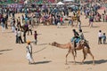 Cameleer entertain children with camels during the rural Desert Festival