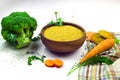 Camelina sativa flour in ceramic bowl, cookies, carrot and broccoli isolated on white background