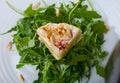 Camembert on arugula with pine nuts