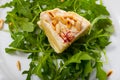 Camembert on arugula with pine nuts