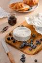 Camembert, blueberries, jam and croissant
