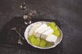 Camembert Brie cheese with grapes in a handmade clay craft plate on a dark background. top view Royalty Free Stock Photo