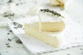 Camembert cheese on a background of garlic and lavender