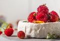 Camembert cheese with fresh raspberries, strawberries, honey and thyme on white background. French appetizer Royalty Free Stock Photo