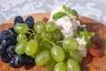 camembert cheese with grapes, honey and nuts on wooden background Royalty Free Stock Photo