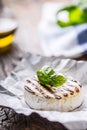 Camembert cheese. Grilled camembert cheese with olive oil and basil leaves Royalty Free Stock Photo