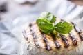 Camembert cheese. Grilled camembert cheese with olive oil and basil leaves Royalty Free Stock Photo