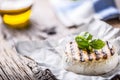 Camembert cheese. Grilled camembert cheese with olive oil and basil leaves Royalty Free Stock Photo