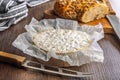 Camembert cheese on wrapping paper. French cheese with mold on the surface Royalty Free Stock Photo
