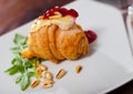 Camembert on mini croissant with jam, pine nuts