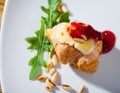 Camembert on mini croissant with jam, pine nuts