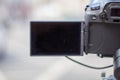Camera with black screen overlooking a blurry street