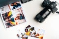 Camera and colorful printed photos of women on desk close up